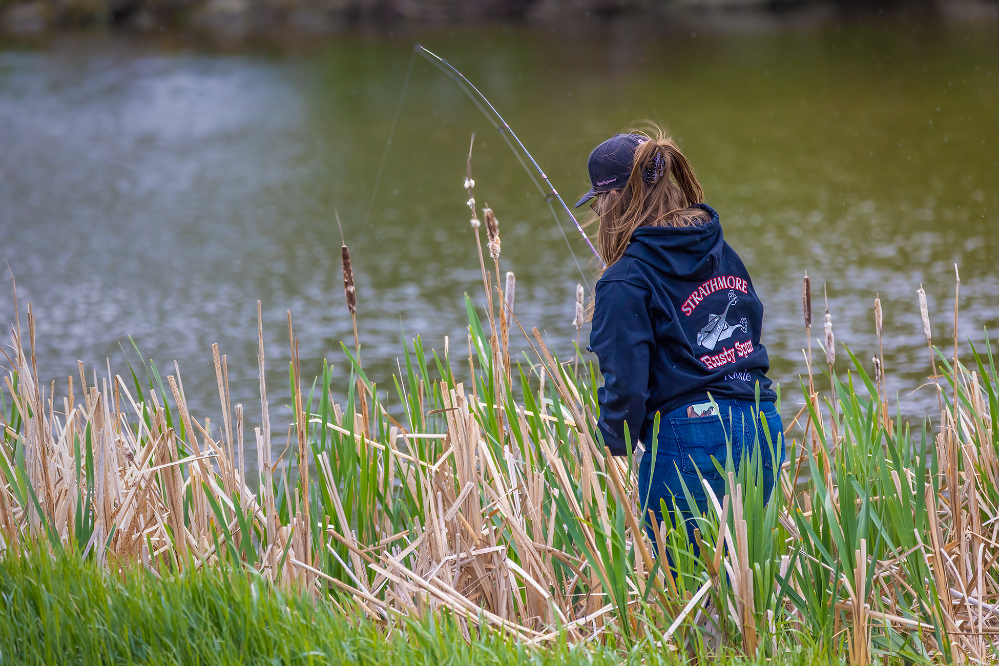 strathmore in pictures — She's reeling one in, Kinsmen Lake, Strathmore, AB, 2026-06-07